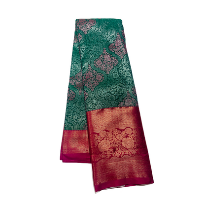 Bottle Green shade Soft kanchi pattu with Pink Border.