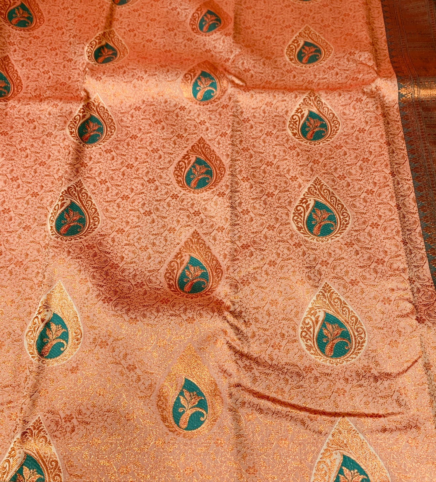 Orange shade Soft kanchi pattu with Green Border with flower design.