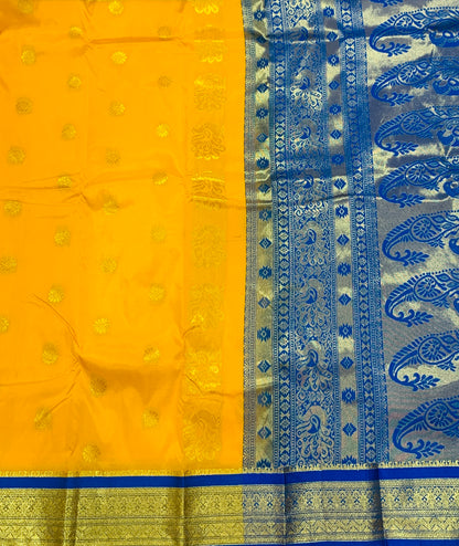 Yellow shade saree with Golden and Blue Border